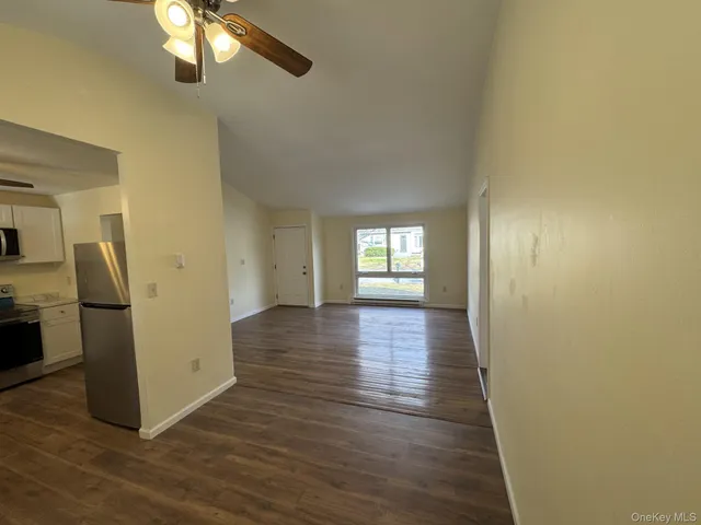 a view of a room with wooden floor