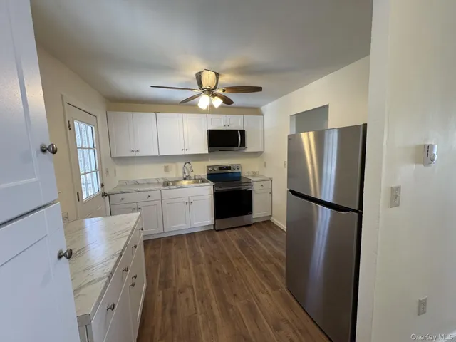 a kitchen with a refrigerator a stove top oven a sink and dishwasher