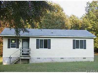 a view of house with a yard