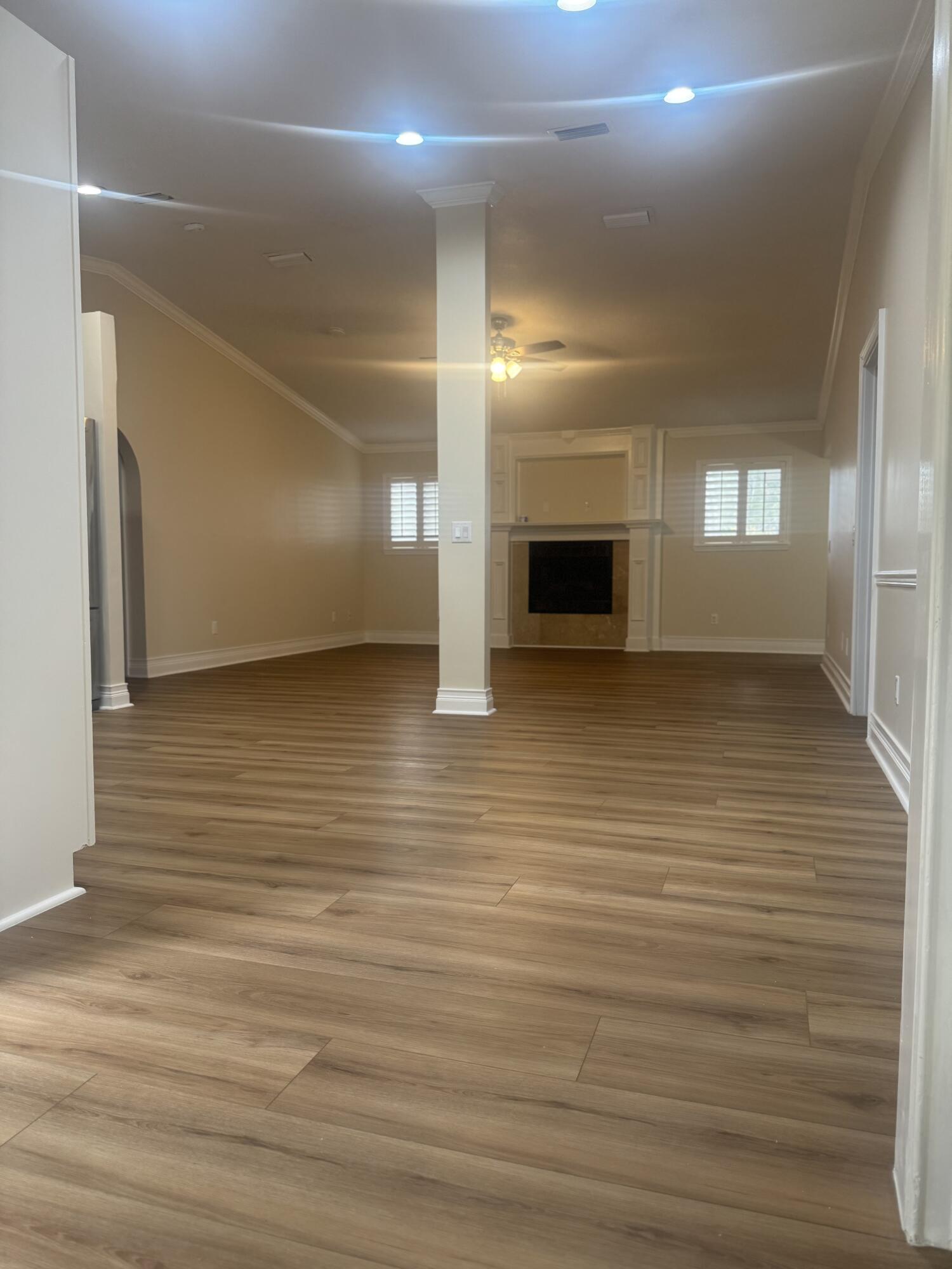 271 Wisteria Road St. Augustine, FL 32086 - Photo 20 of 30 an empty room with wooden floor and fireplace