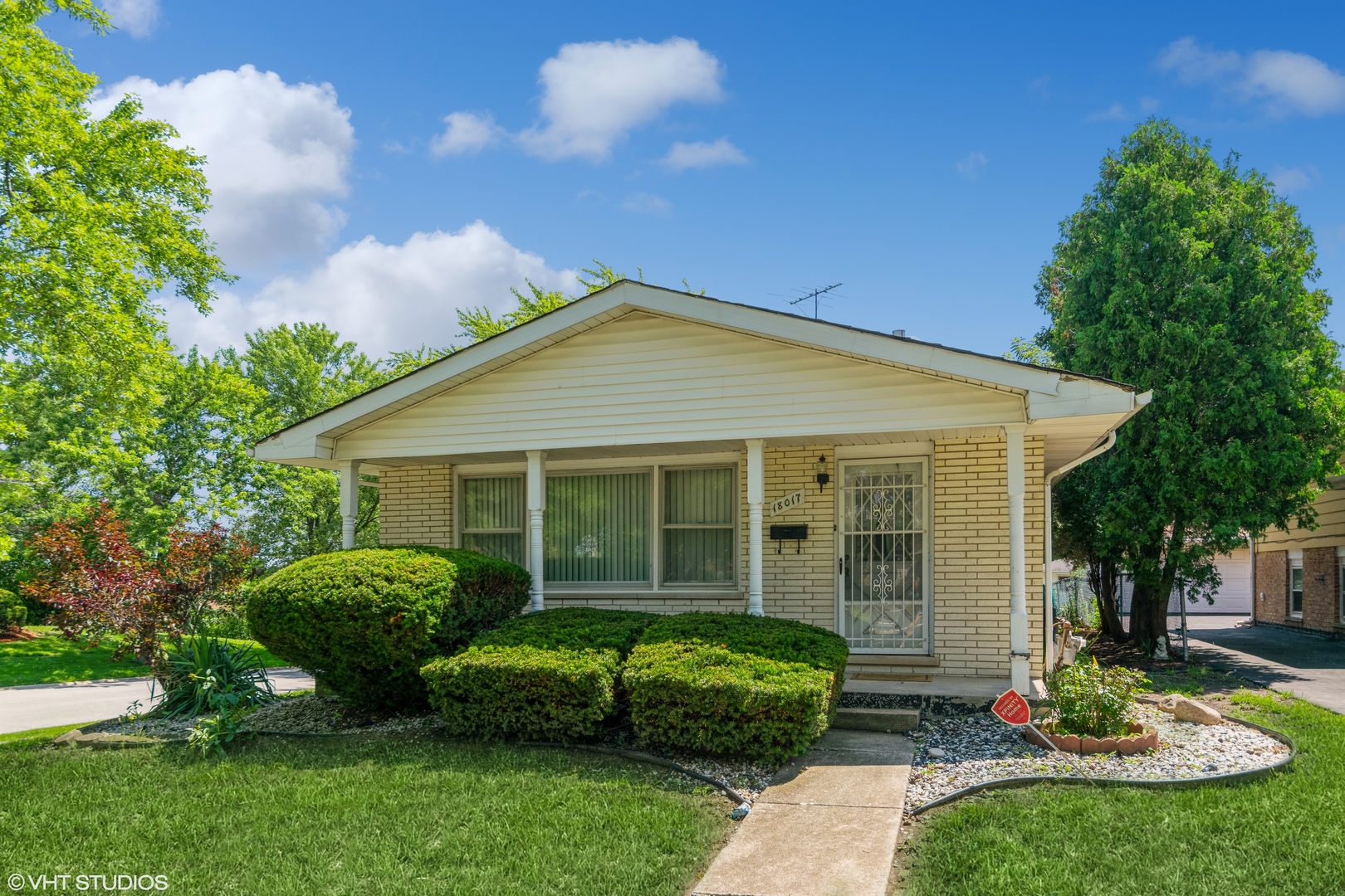 a view of a house with a yard and plants
