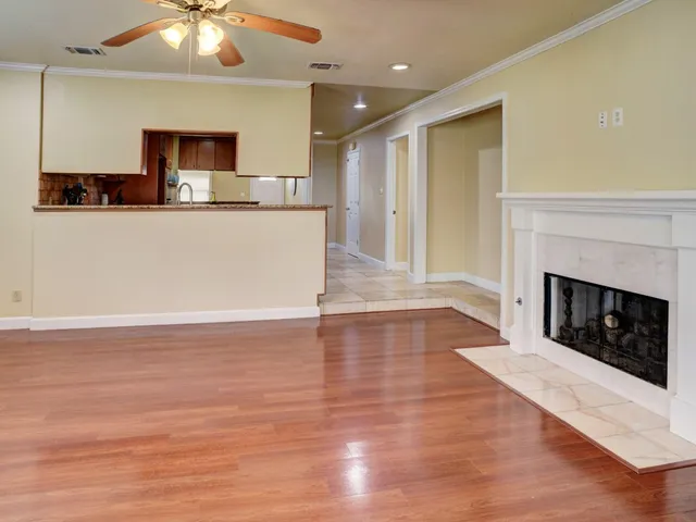 a view of kitchen with granite countertop fireplace with wooden floor