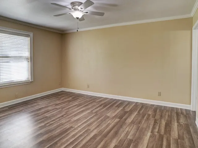 wooden floor in an empty room with a window