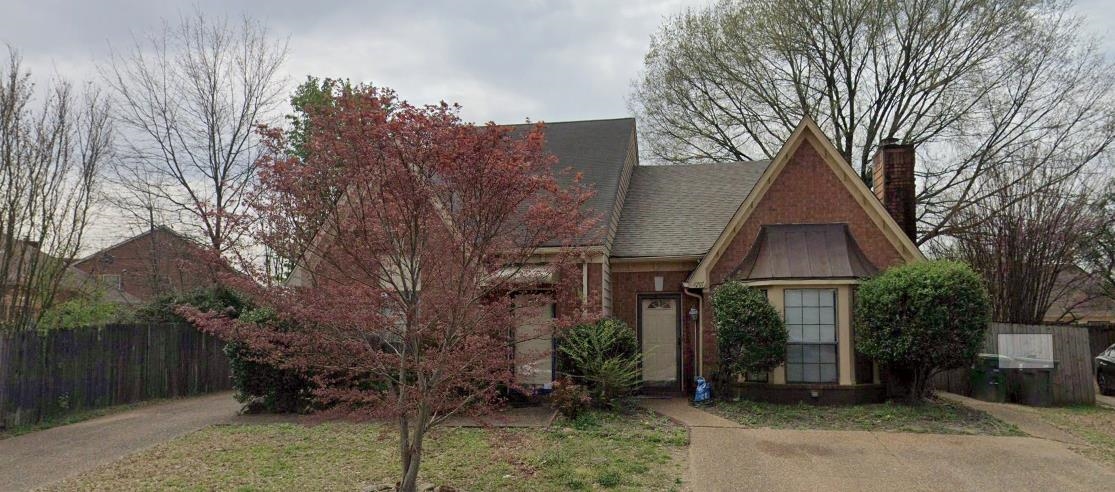 a view of a house with a yard and tree s