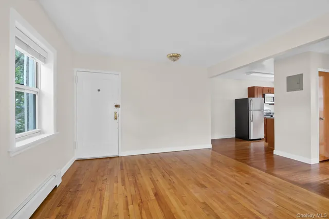a view of a livingroom with wooden floor and staircase