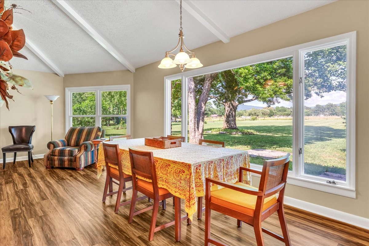 183 Prairie Plains Road Hillsboro, TN 37342 - Photo 14 of 63 a view of a dining room with furniture large windows and wooden floor