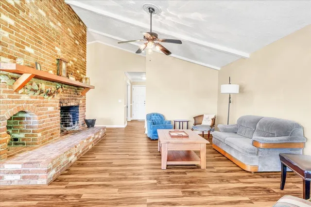 a view of a house with a yard and sitting area