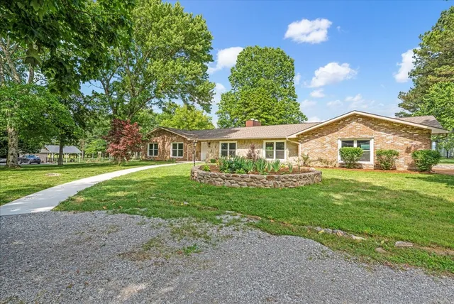 a front view of house with yard and green space