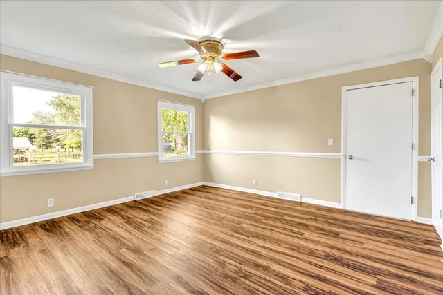 a view of a room with wooden chairs and furniture