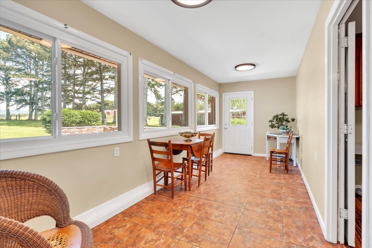183 Prairie Plains Road Hillsboro, TN 37342 - Photo 27 of 63 a dining room with furniture and a floor to ceiling window