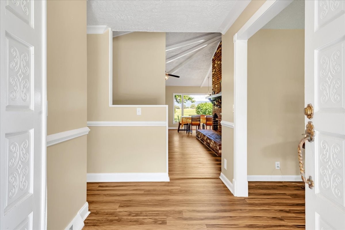 183 Prairie Plains Road Hillsboro, TN 37342 - Photo 6 of 63 a view of a hallway with wooden floor and a living room