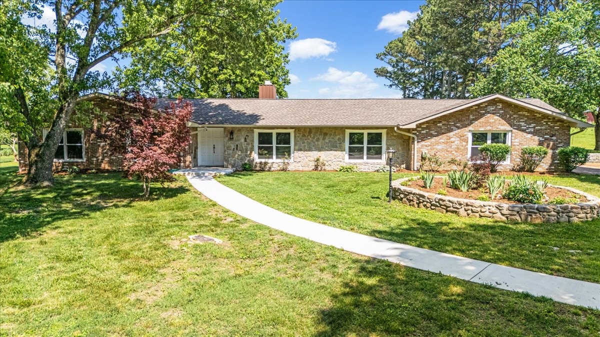 183 Prairie Plains Road Hillsboro, TN 37342 - Photo 62 of 63 a front view of a house with a yard table and chairs