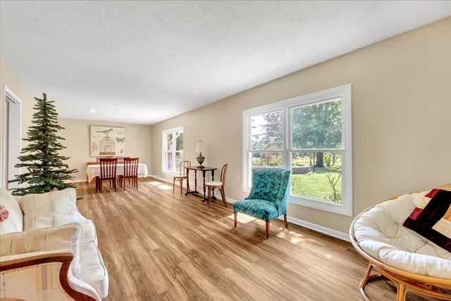 a dining room with furniture and a floor to ceiling window