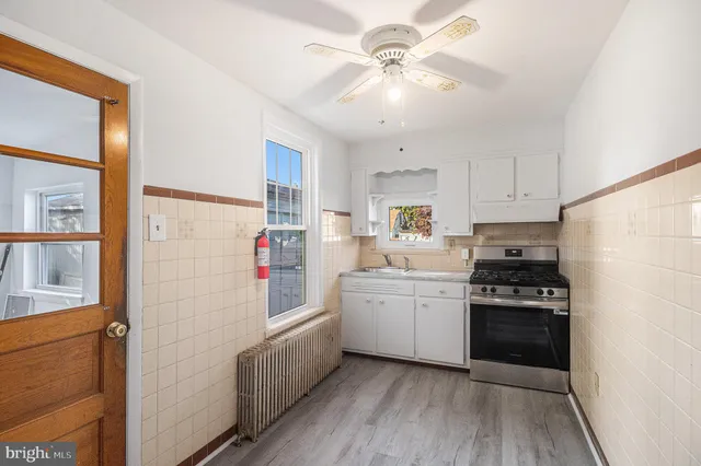 a kitchen with white cabinets and white appliances