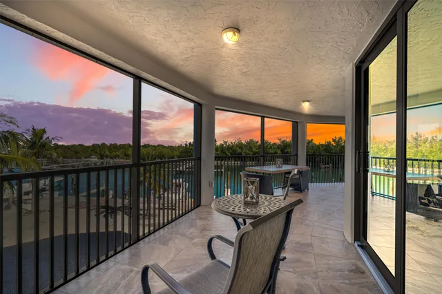 a dining room with furniture a chandelier and wooden floor