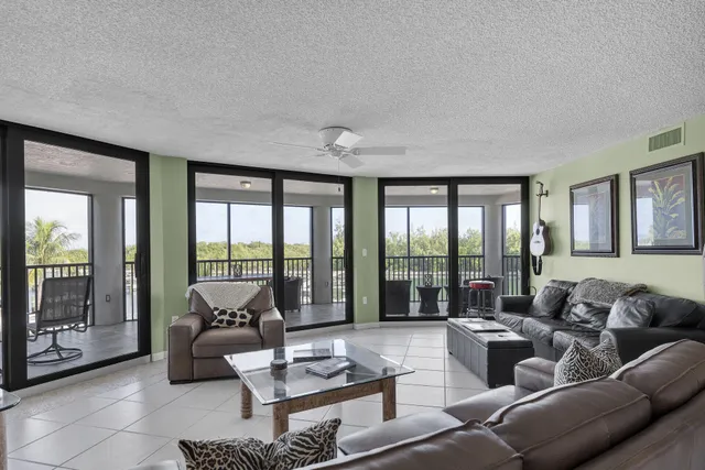a bedroom with a bed and large windows