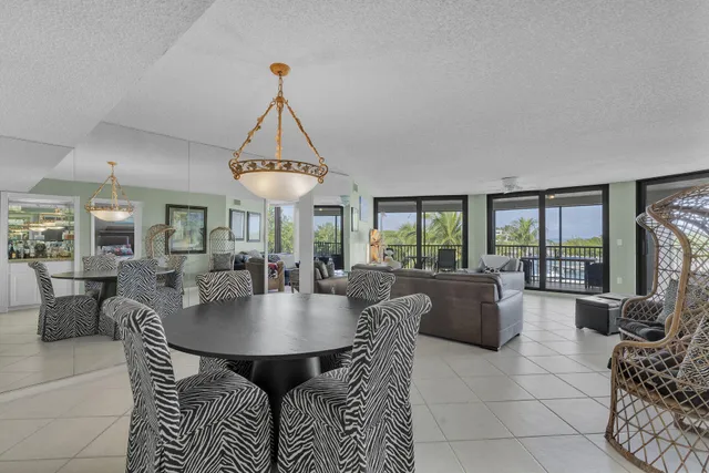 a view of a swimming pool with a yard and palm trees