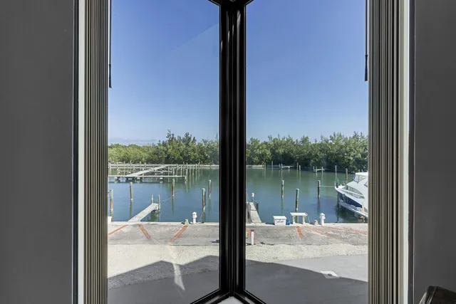 a living room with furniture and a floor to ceiling window