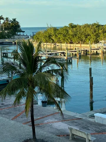 a view of a kitchen with granite countertop a sink a counter top space and living room view