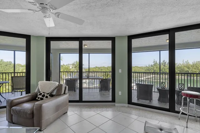 a kitchen with granite countertop white cabinets and stainless steel appliances
