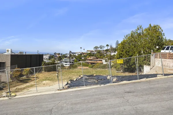 a view of a swimming pool with a yard and lake view