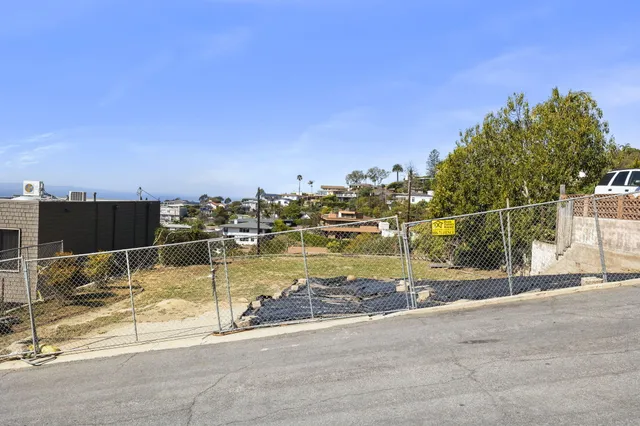 a view of a swimming pool with a yard and lake view