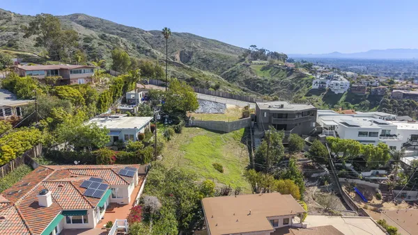 an aerial view of a house with mountain view