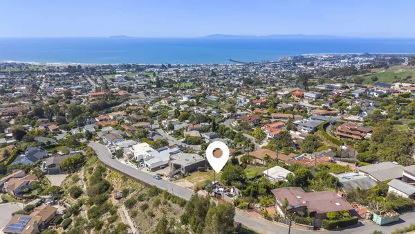an aerial view of a house with a yard