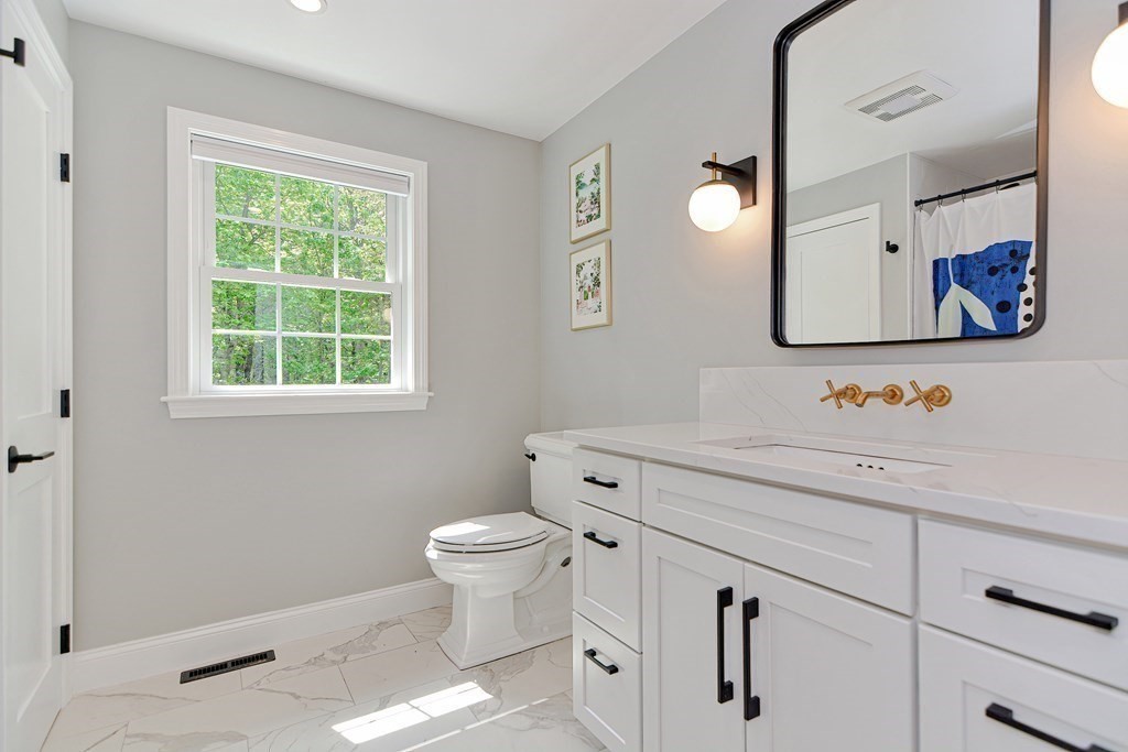 9 Woodcliff Road Canton, MA 02021 - Photo 17 of 42 a bathroom with a sink toilet and window