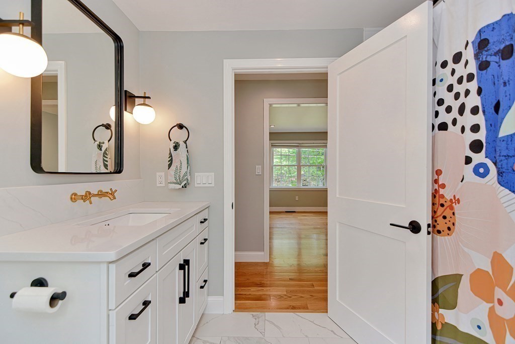9 Woodcliff Road Canton, MA 02021 - Photo 18 of 42 a bathroom with a sink and a mirror