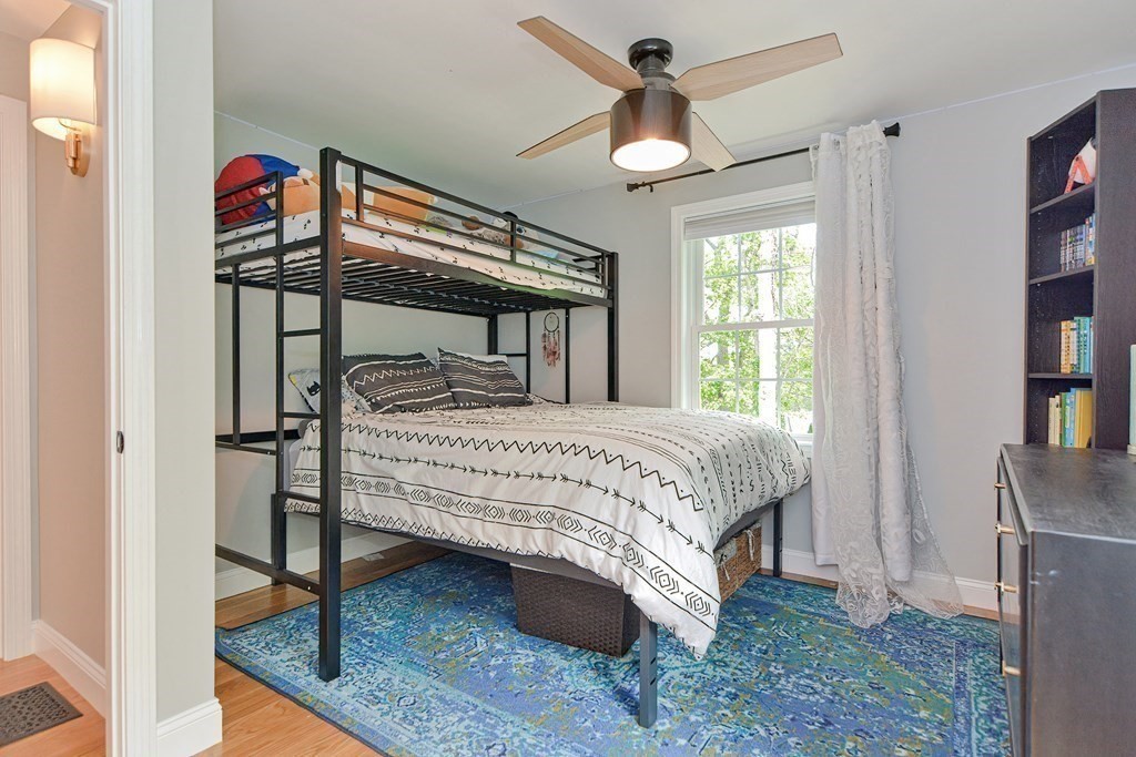 9 Woodcliff Road Canton, MA 02021 - Photo 21 of 42 a bedroom with a bed and a chandelier