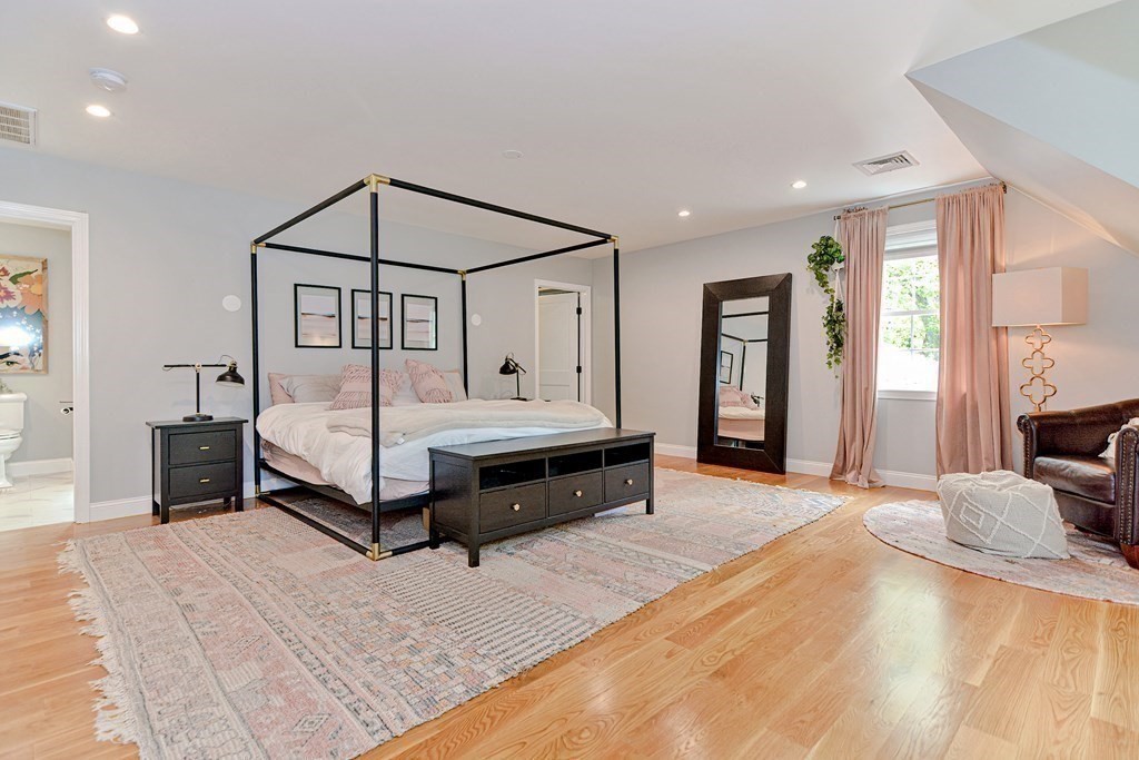9 Woodcliff Road Canton, MA 02021 - Photo 30 of 42 a spacious bedroom with a bed and a chandelier