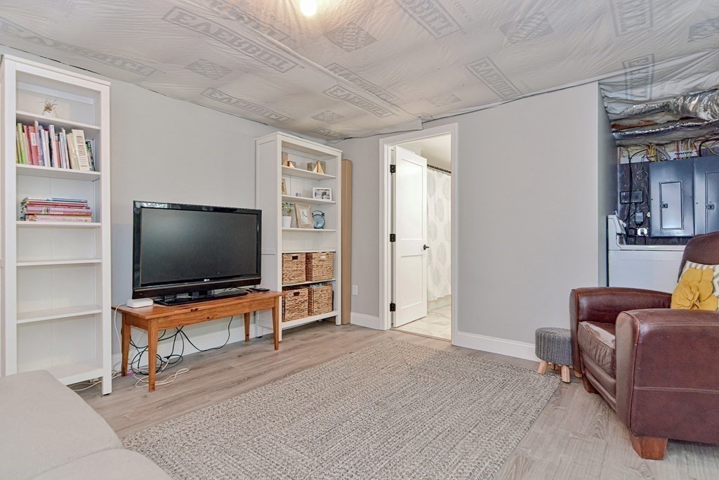 9 Woodcliff Road Canton, MA 02021 - Photo 39 of 42 a living room with furniture and a flat screen tv