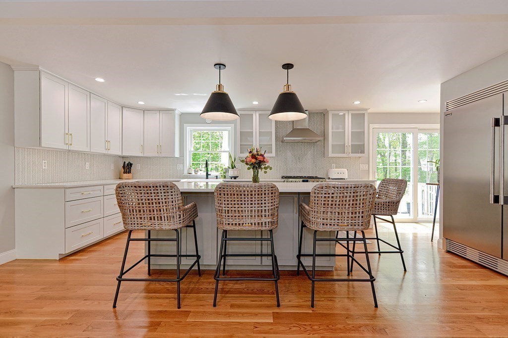 9 Woodcliff Road Canton, MA 02021 - Photo 10 of 42 a kitchen with stainless steel appliances a dining table chairs and wooden floor