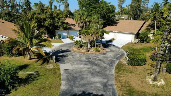 an aerial view of a house with swimming pool garden and patio