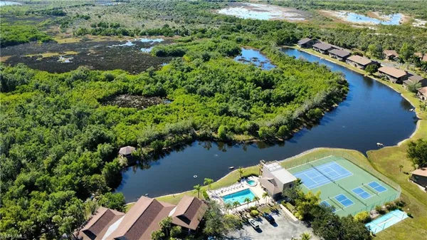 an aerial view of lake residential house with swimming pool and outdoor seating