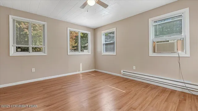 a view of room with window and ceiling fan