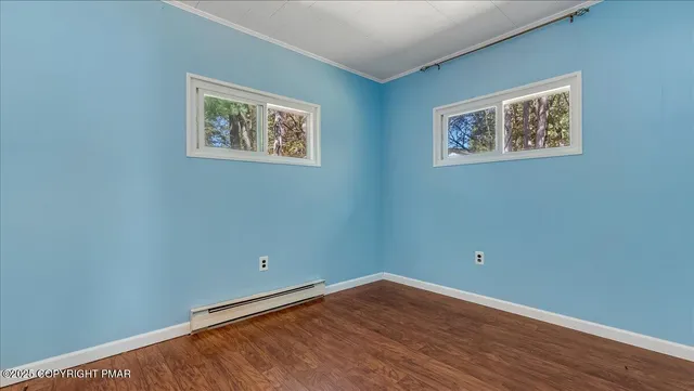 a view of a room with wooden floor and window