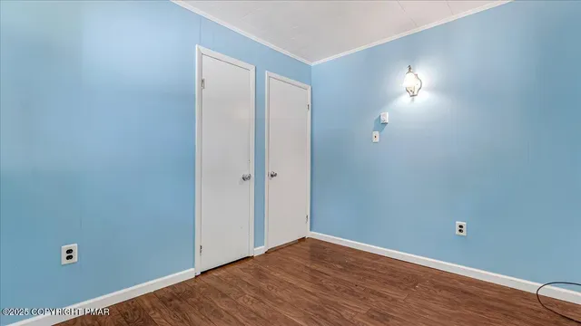 a view of room with wooden floor