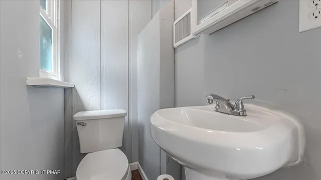 a white toilet sitting next to a white sink