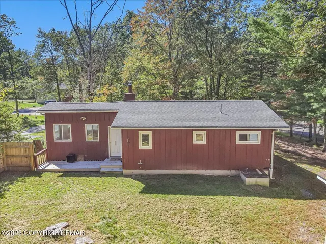 a view of backyard with cabin