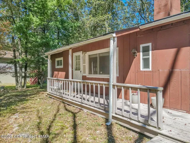 a view of a house with backyard and deck