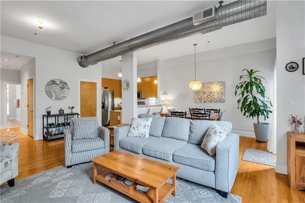 a living room with furniture and potted plants