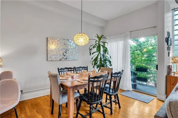 a dining room with furniture and potted plants