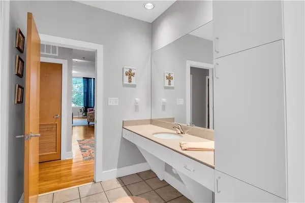 a bathroom with a sink a mirror and a shower