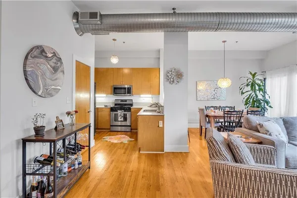 a living room with furniture a fireplace and wooden floor