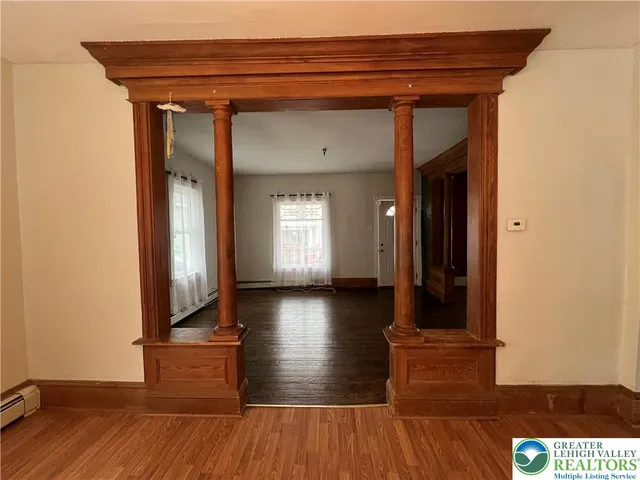a view of a livingroom with wooden floor and stairs
