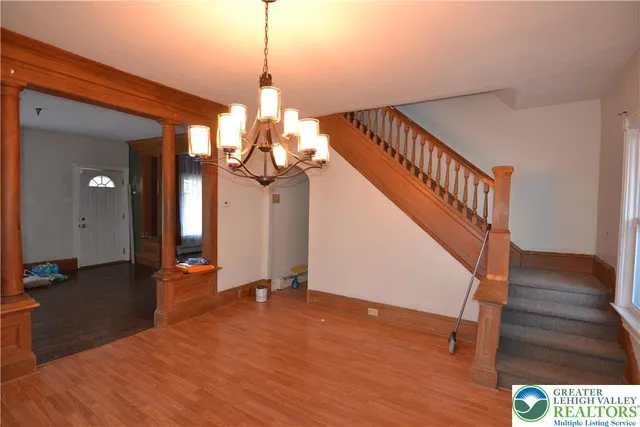 a kitchen with stainless steel appliances granite countertop a refrigerator a stove a sink dishwasher and a refrigerator with wooden floor