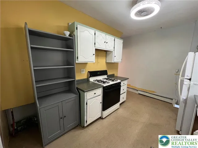 a utility room with wooden floor washer and dryer