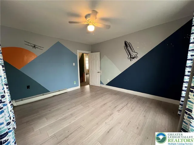 a view of a ceiling fan and wooden floor